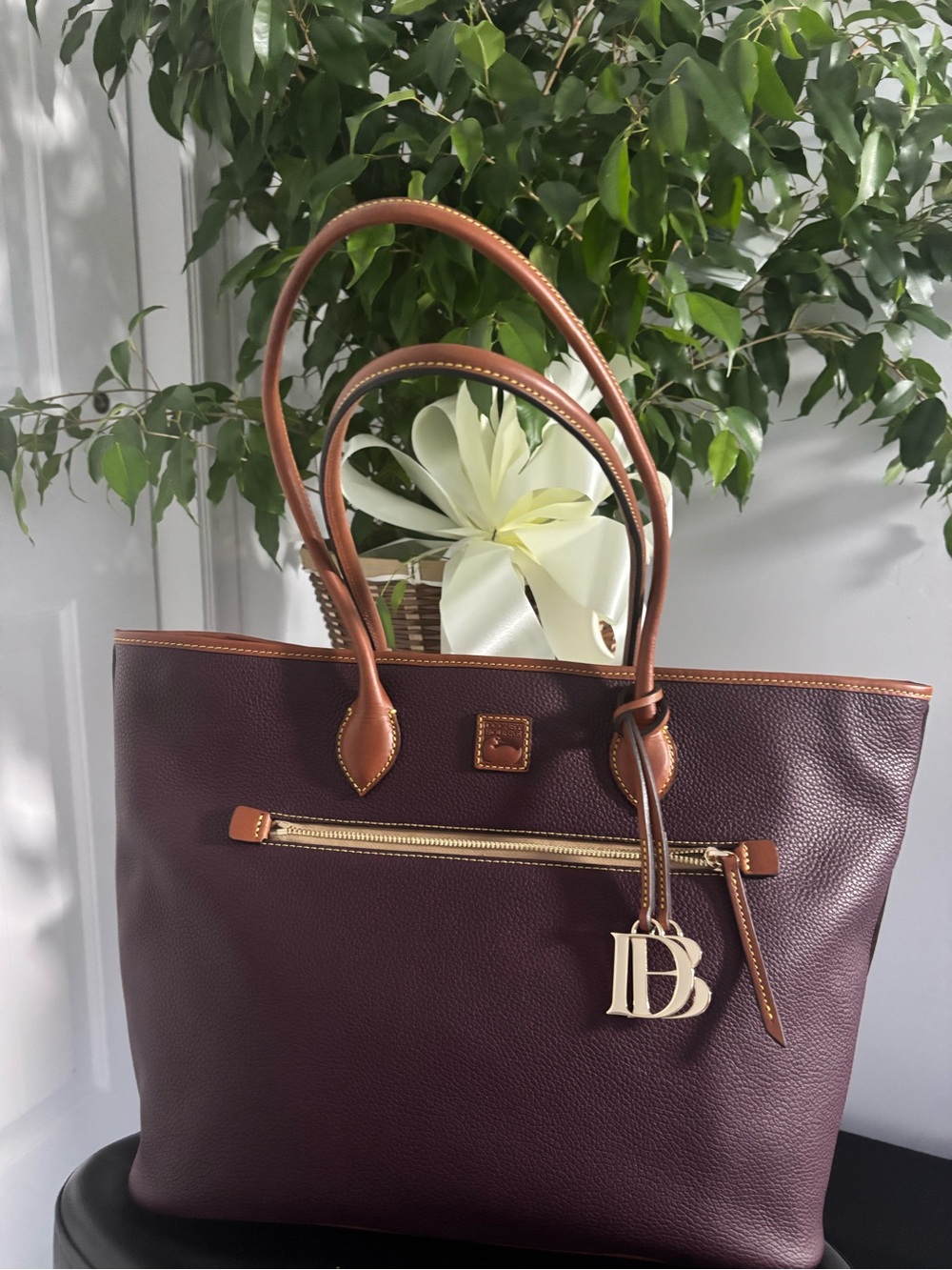 Dooney & Bourke Burgundy Leather Tote with Tan Trim and Gold Charm